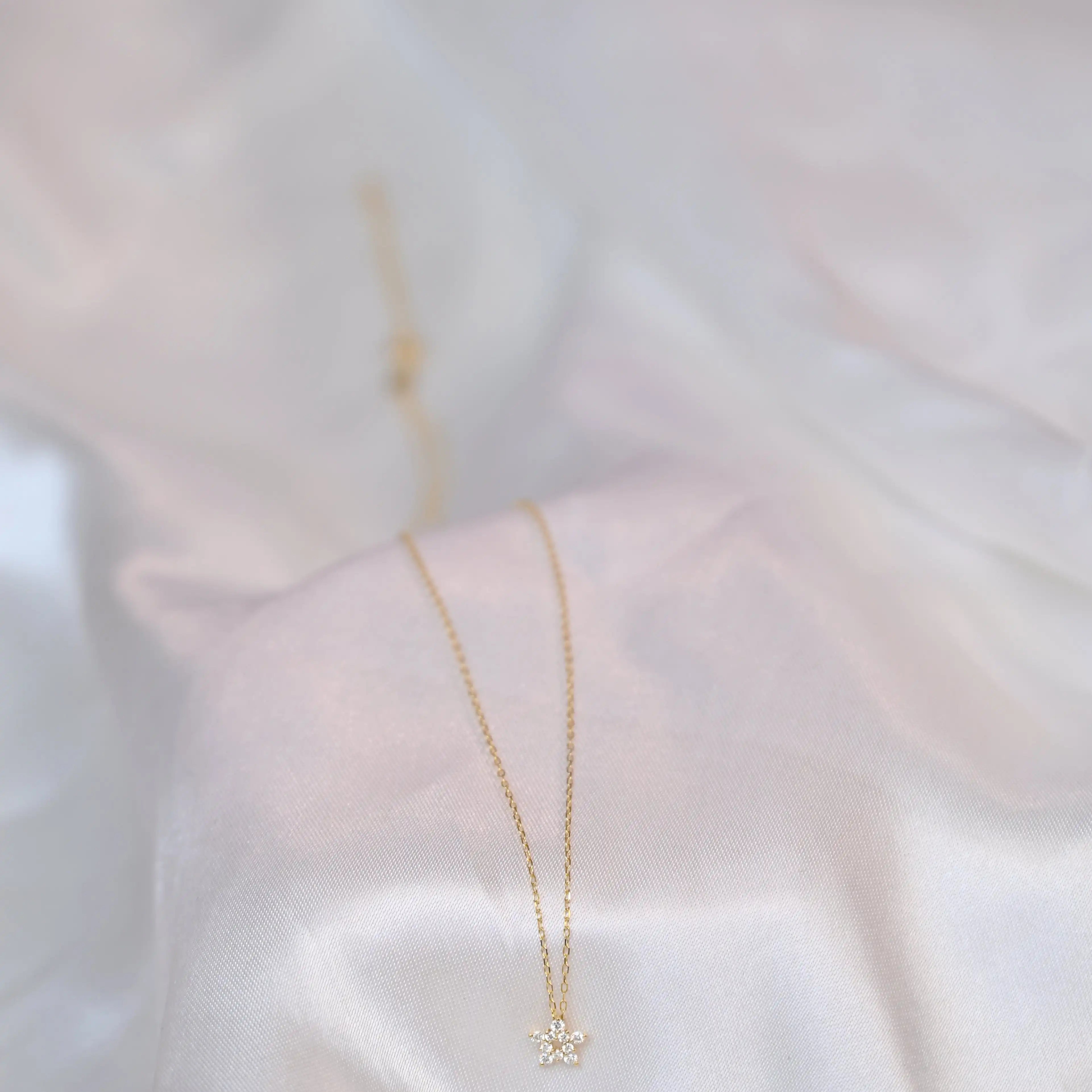 Crocus Diamond Necklace in 18K gold with 13 sparkling SI clarity on a white silk display background