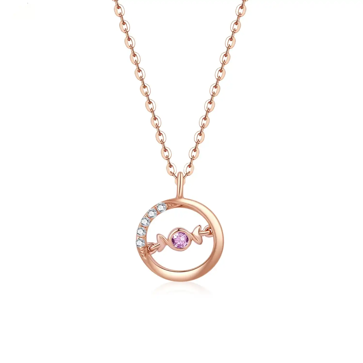 A delicate 18K rose gold necklace with a circular pendant featuring a round pink sapphire in the center and a curved row of small white diamonds on one side. The pendant hangs from a thin gold chain.