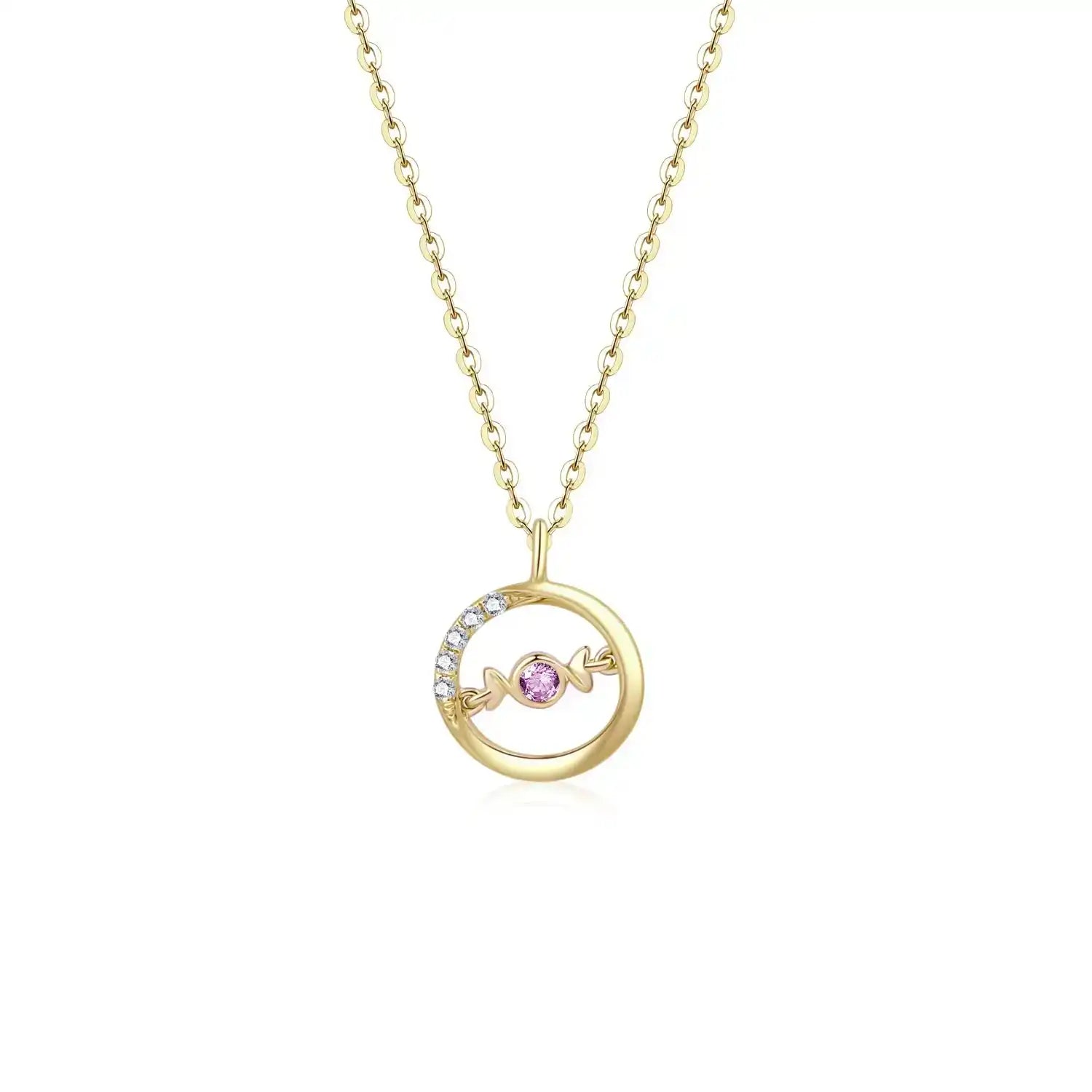 A delicate 18K yellow gold necklace with a circular pendant featuring a round pink sapphire in the center and a curved row of small white diamonds on one side. The pendant hangs from a thin gold chain.
