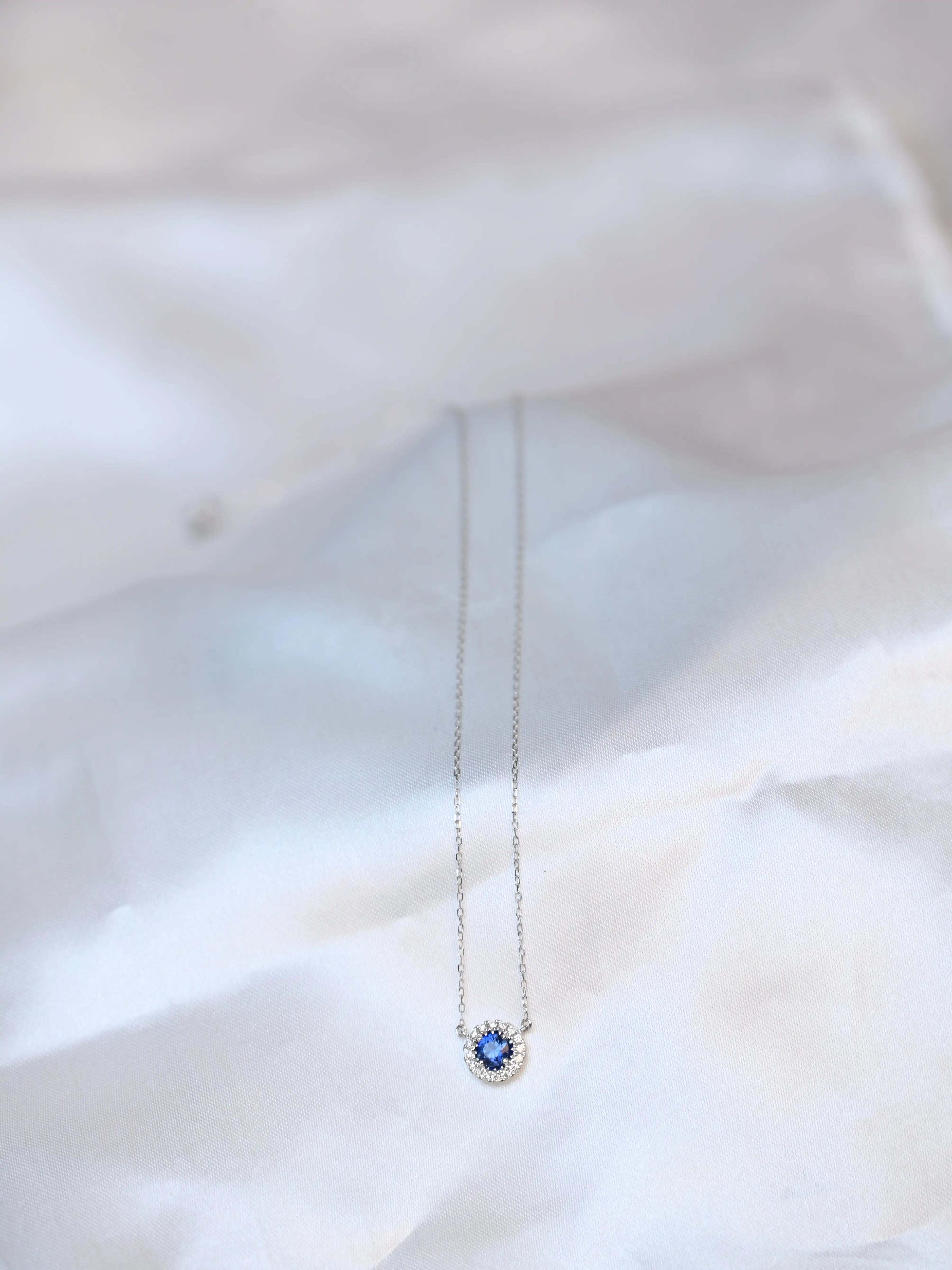 Michal Royalty Sapphire Necklace - King David sitting on a silk cloth background