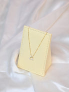18K yellow gold necklace with crossed triangle diamond pendant – minimalist geometric gold jewelry for women